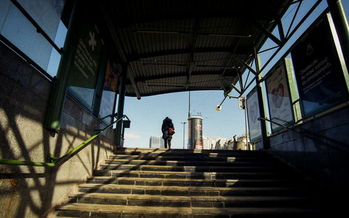 Low angle view of people on staircase against sky