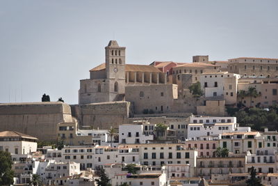 Buildings in city against clear sky