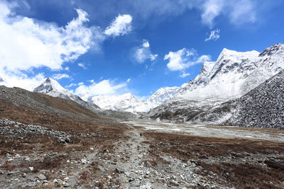 Scenic view of mountains against cloudy sky