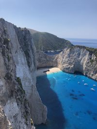 Scenic view of sea and mountains against sky