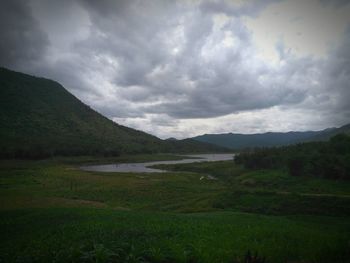 Scenic view of landscape against cloudy sky