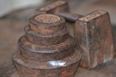 Old-fashioned weights on wooden plank