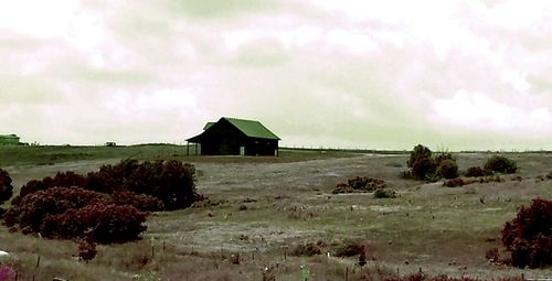 Scenic view of landscape against cloudy sky