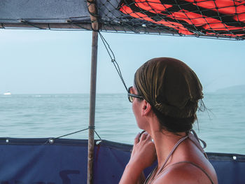 Portrait of man wearing sunglasses at sea against sky