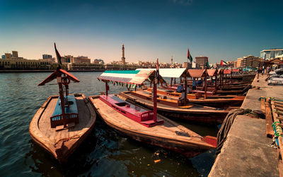 Boats moored at harbor