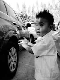 Side view of boy holding car