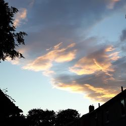 High section of building against sky at sunset