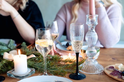 Two glasses of alcohol on the new year's table. a glass of champagne and a cocktail with lemon 