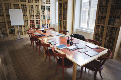 Empty chairs with table in board room at law library