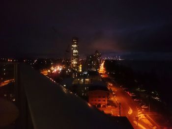 Illuminated cityscape against sky at night