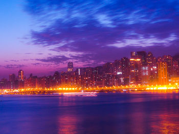 Illuminated buildings against sky at night