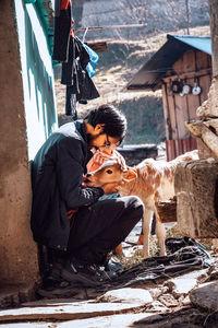 Friends and woman standing against built structure