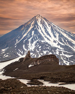 Scenic view of snowcapped mountains against sky during sunset