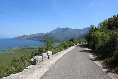 View of country road against mountain range