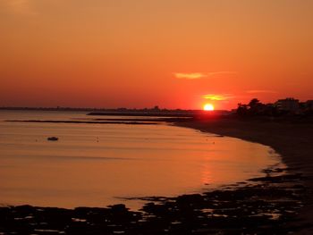 Scenic view of sea against orange sky