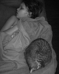 Close-up of young woman sleeping on bed at home