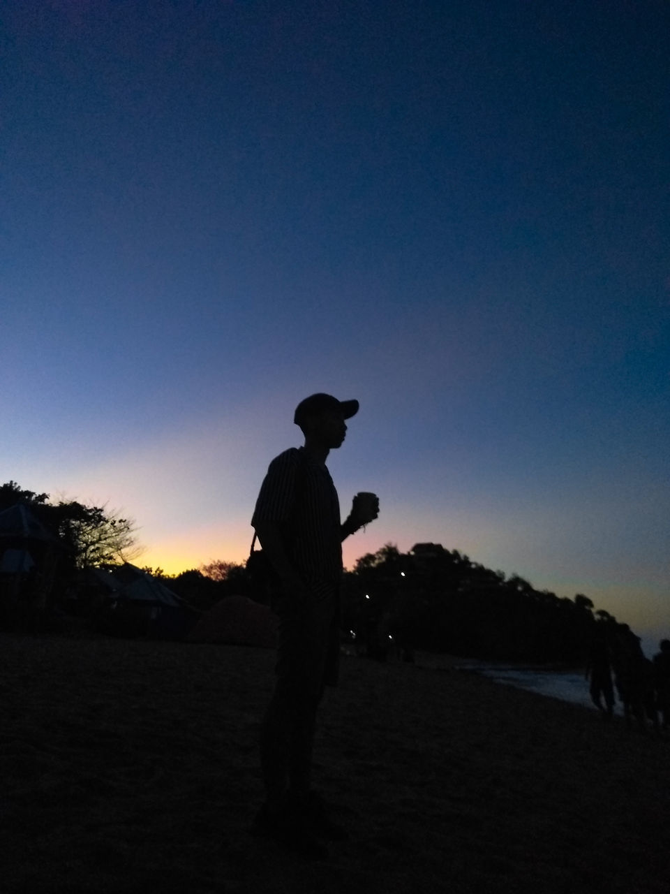 silhouette, sky, sunset, men, copy space, standing, land, one person, leisure activity, real people, lifestyles, clear sky, nature, beauty in nature, side view, full length, field, scenics - nature, outdoors