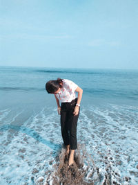 Full length of man standing on beach