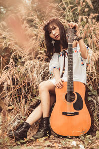 Woman sitting guitar