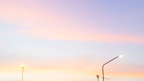 Low angle view of street light against sky during sunset