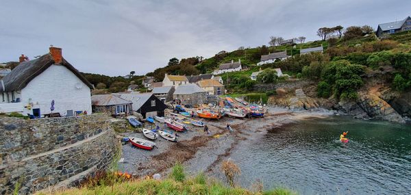 High angle view of houses by sea against sky