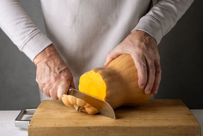 Midsection of man holding pumpkin