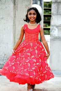 Portrait of happy girl in red dress