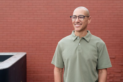 Portrait of man standing against wall