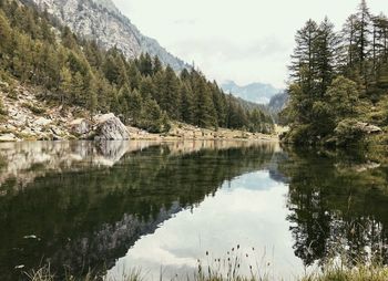 Scenic view of lake and mountains against sky