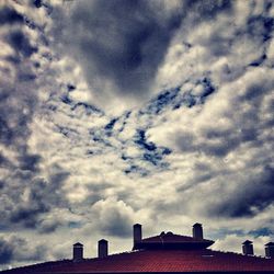 High section of building against cloudy sky