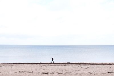 Person walking on shore at baltic sea