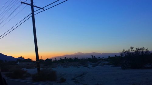 Scenic view of landscape against clear sky at sunset