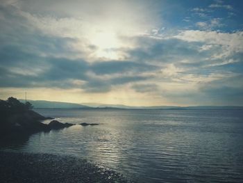 Scenic view of sea against cloudy sky