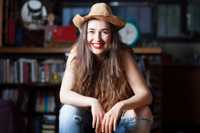 Portrait of woman smiling while sitting at home