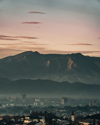 Aerial view of townscape against sky during sunset