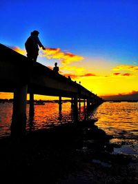 Silhouette of pier at sunset