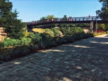 Bridge over footpath against sky