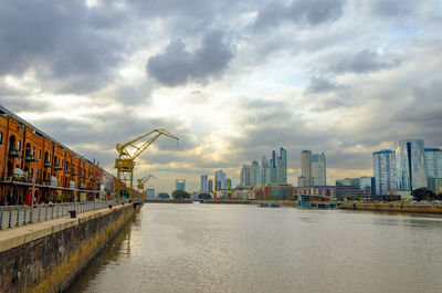 Puerto madero against cloudy sky