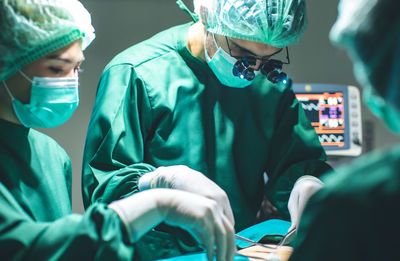 Male and female doctors in operation room