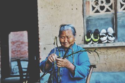 Senior woman holding branches