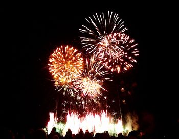 Low angle view of firework display at night