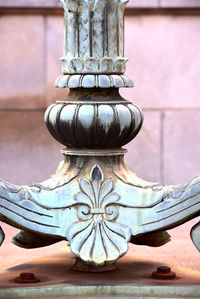 Close-up of old statue against wall