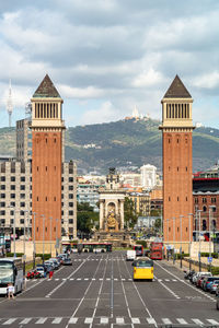 View of city buildings against cloudy sky