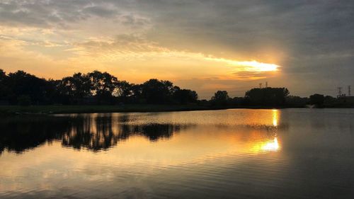 Scenic view of lake against orange sky