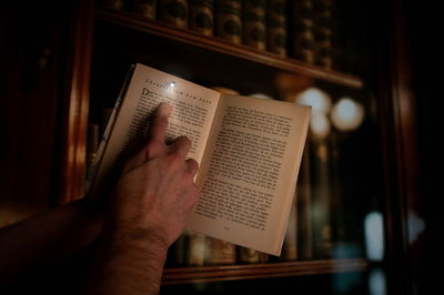 Book with a miniature lamp in a library.