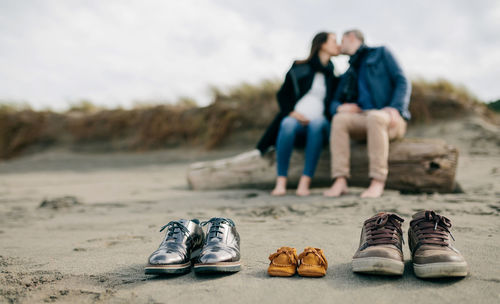 Shoes with couple kissing in background