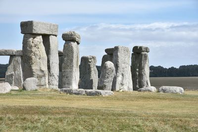 Stone structure on field against sky