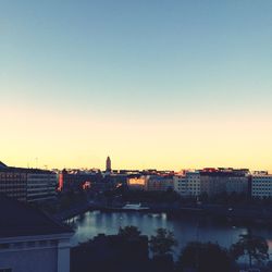Scenic view of city against clear sky during sunset