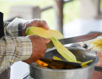 Midsection of man preparing food