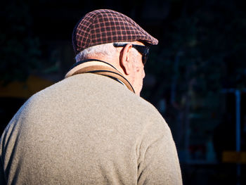 Rear view of man wearing hat while standing outdoors